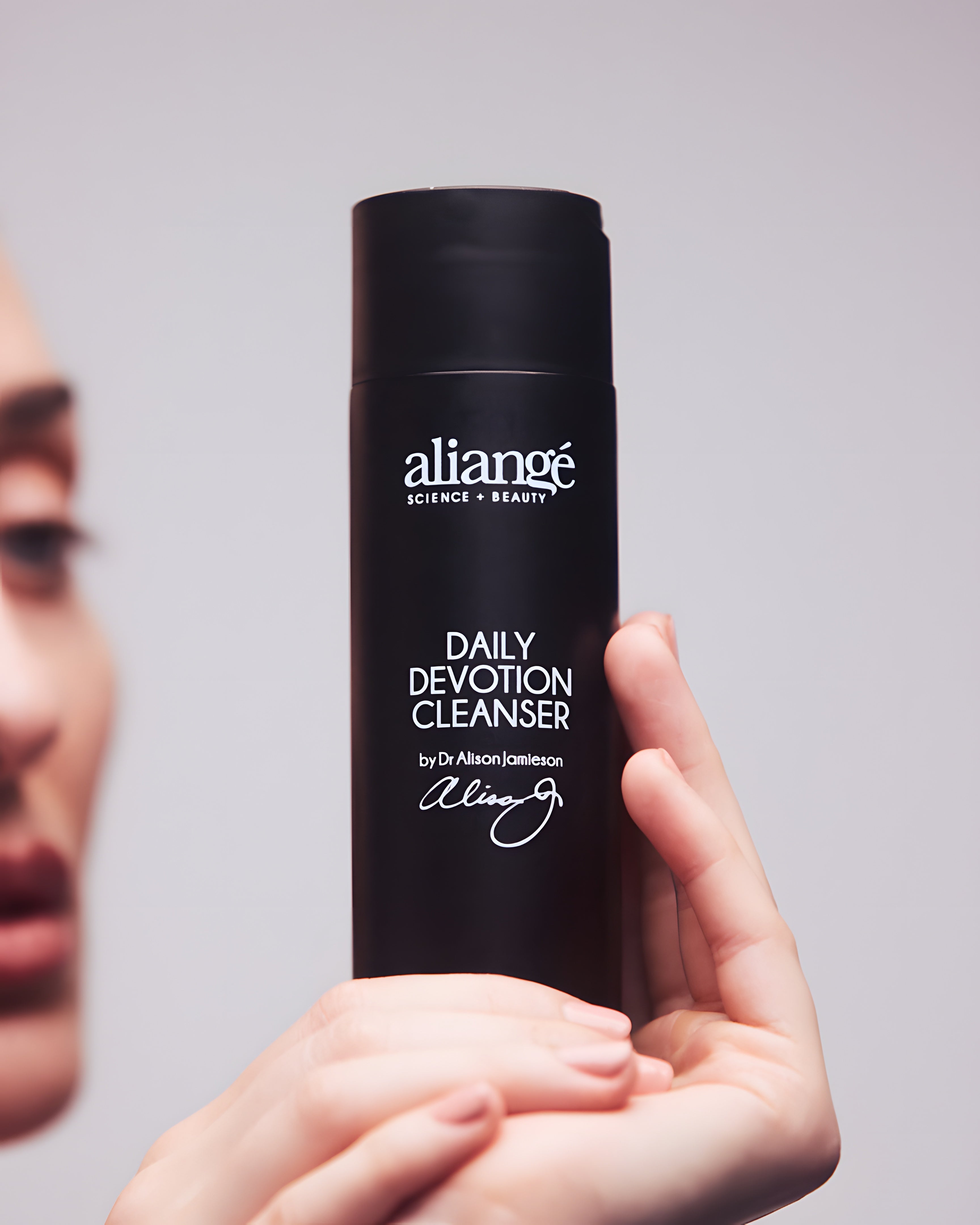 Woman cleansing with Aliangé Daily Devotion Cleanser — daily cream cleanser lifestyle image