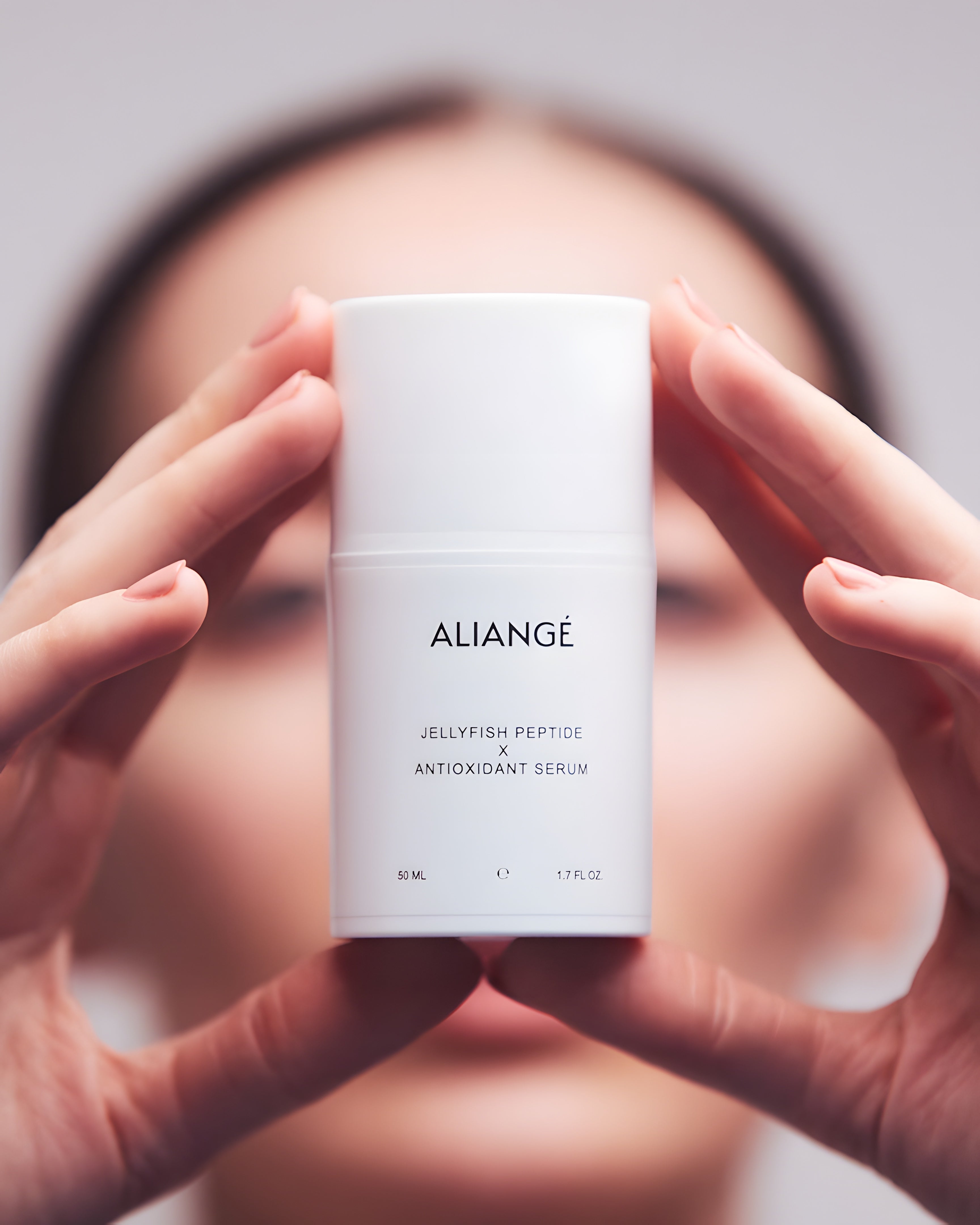 Woman applying Aliangé Jellyfish Peptide × Antioxidant Serum — peptide repair serum in use