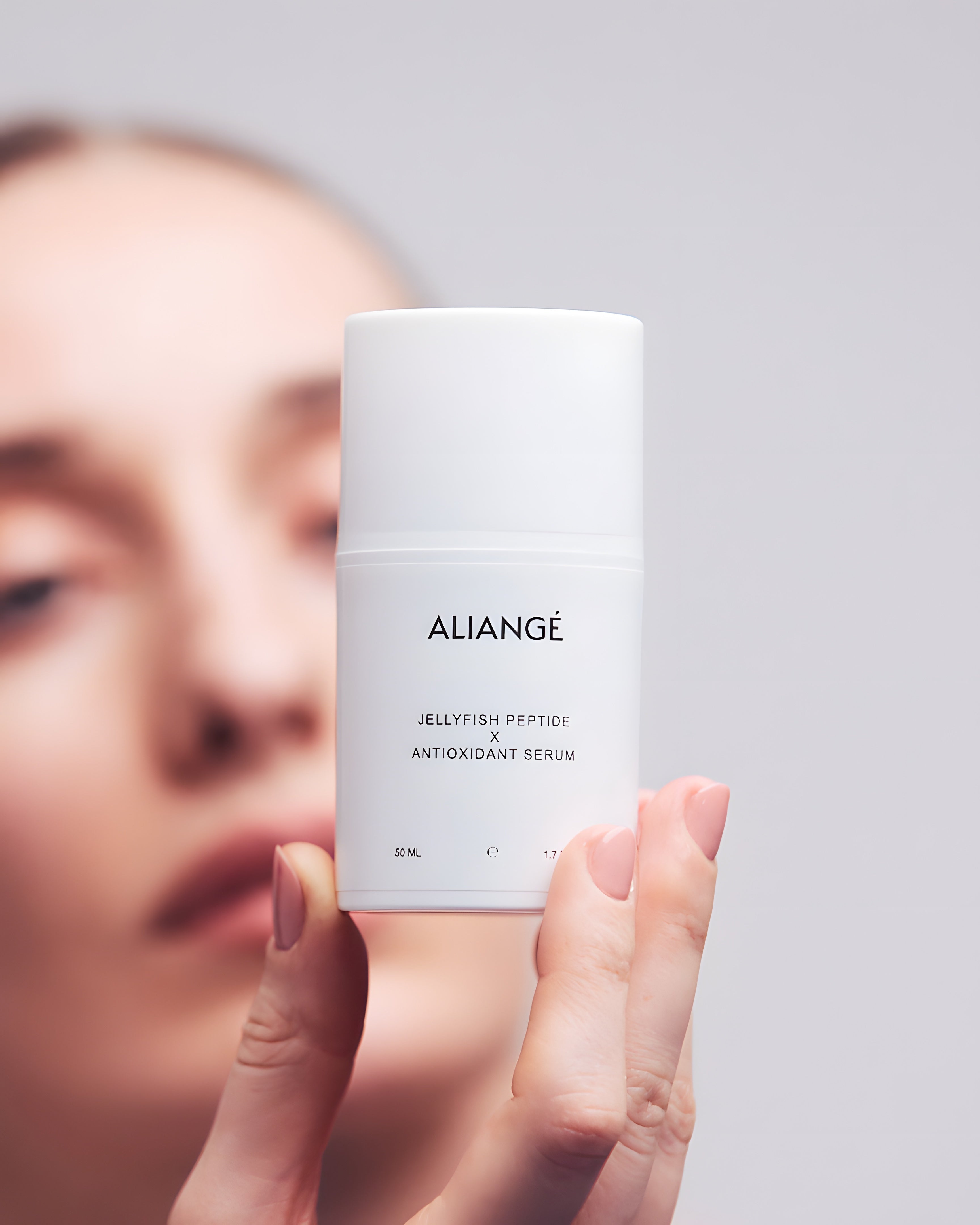 Woman applying Aliangé Jellyfish Peptide × Antioxidant Serum — peptide repair serum in use
