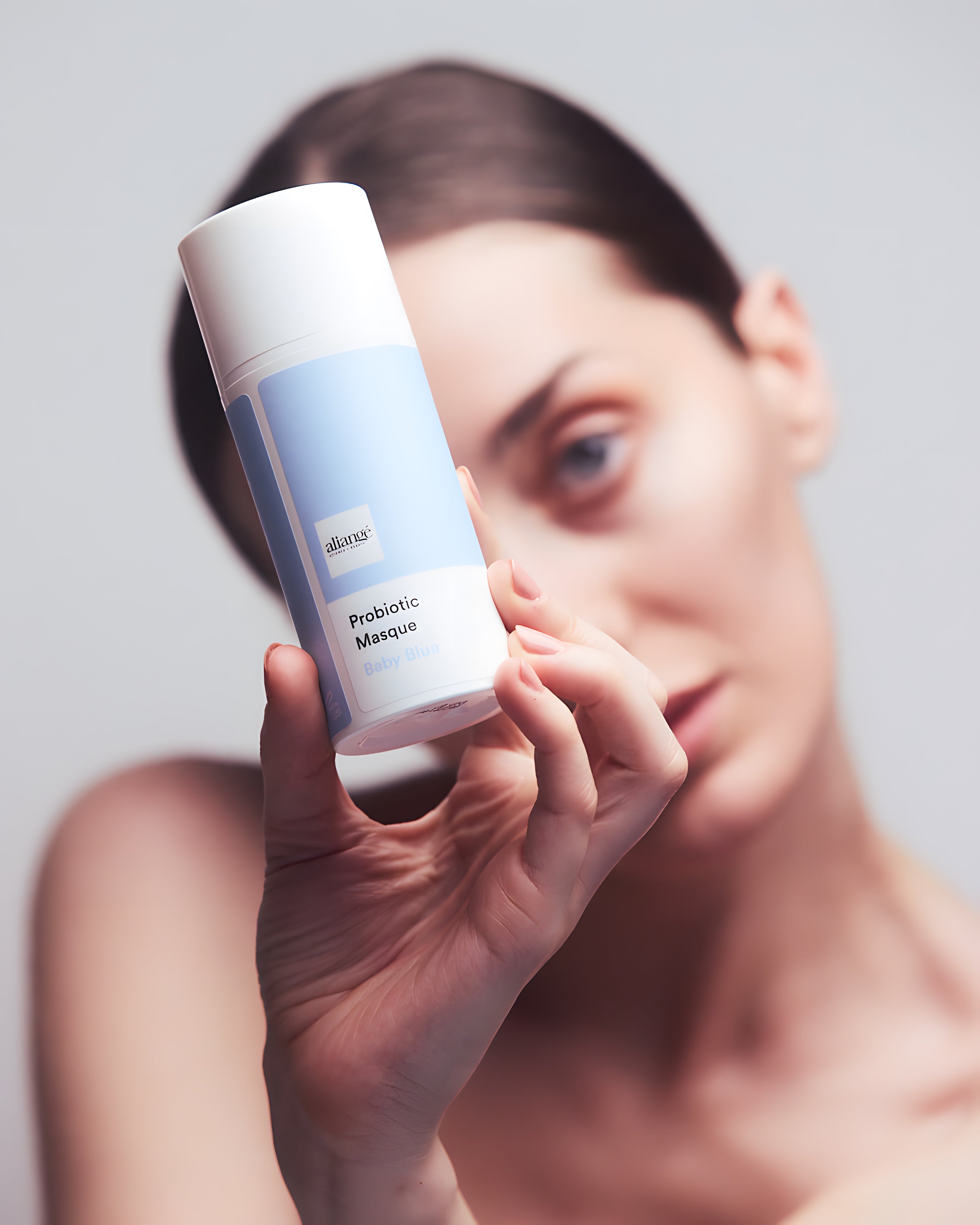 Woman applying Aliangé Probiotic Masque — probiotic microbiome treatment in use