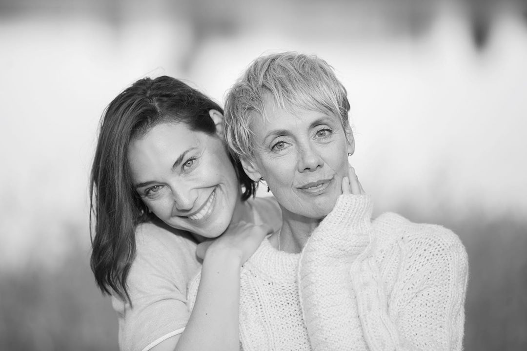 Two women cheek to cheek in black and white, one silver-haired — hyaluronic acid article