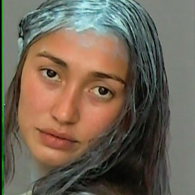 Woman with a blue-grey masque worked through her hair and across her face — serum versus cream article