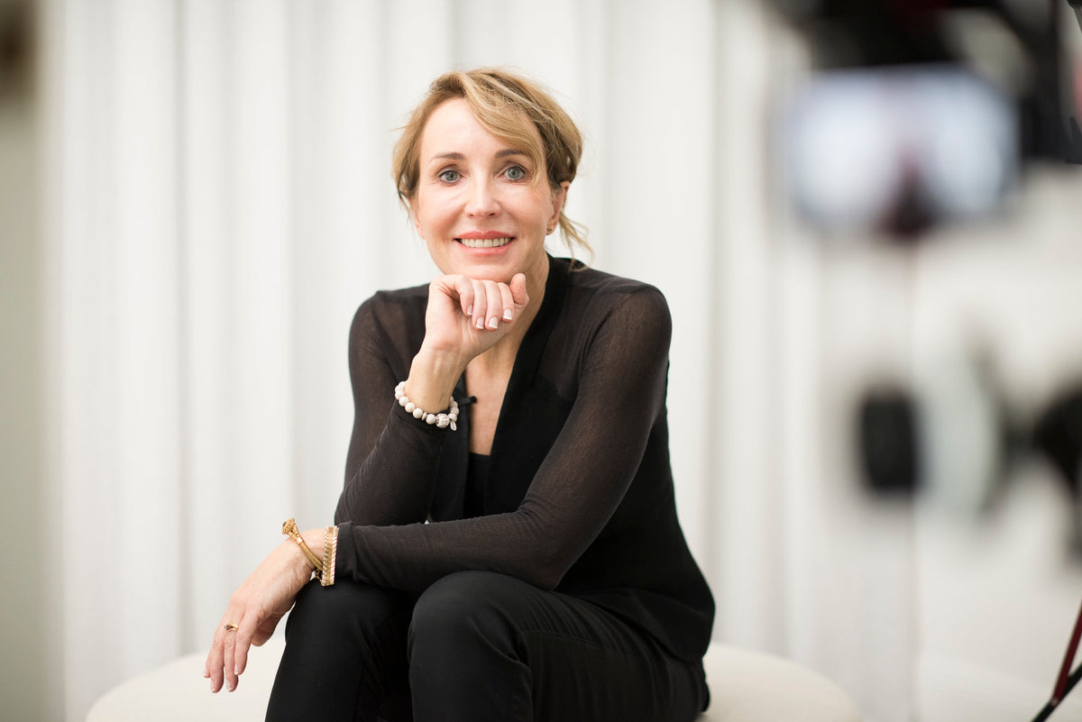 Dr Alison Jamieson, Cosmetic Physician, seated on set for an Aliangé founder update
