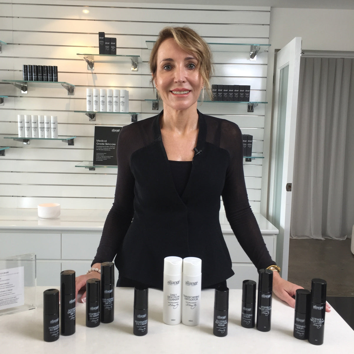 Dr Alison Jamieson behind a bench of Aliangé products in the clinic dispensary