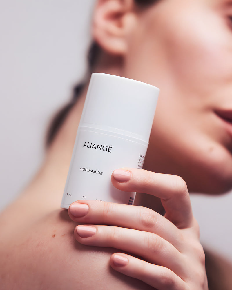 Woman applying Aliangé Biocinamide — niacinamide barrier serum in use
