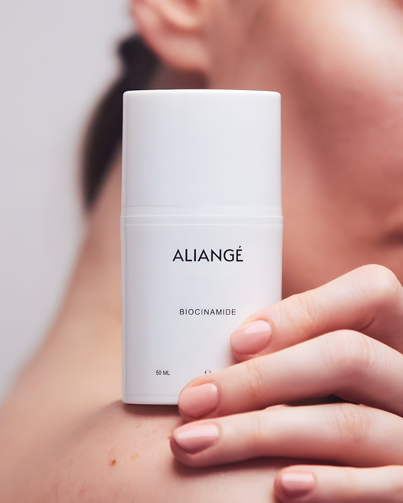 Woman applying Aliangé Biocinamide — niacinamide barrier serum in use