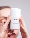 Woman applying Aliangé Brightening Serum — vitamin C pigmentation serum in use