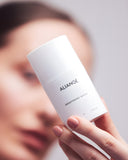 Woman applying Aliangé Brightening Serum — vitamin C pigmentation serum in use