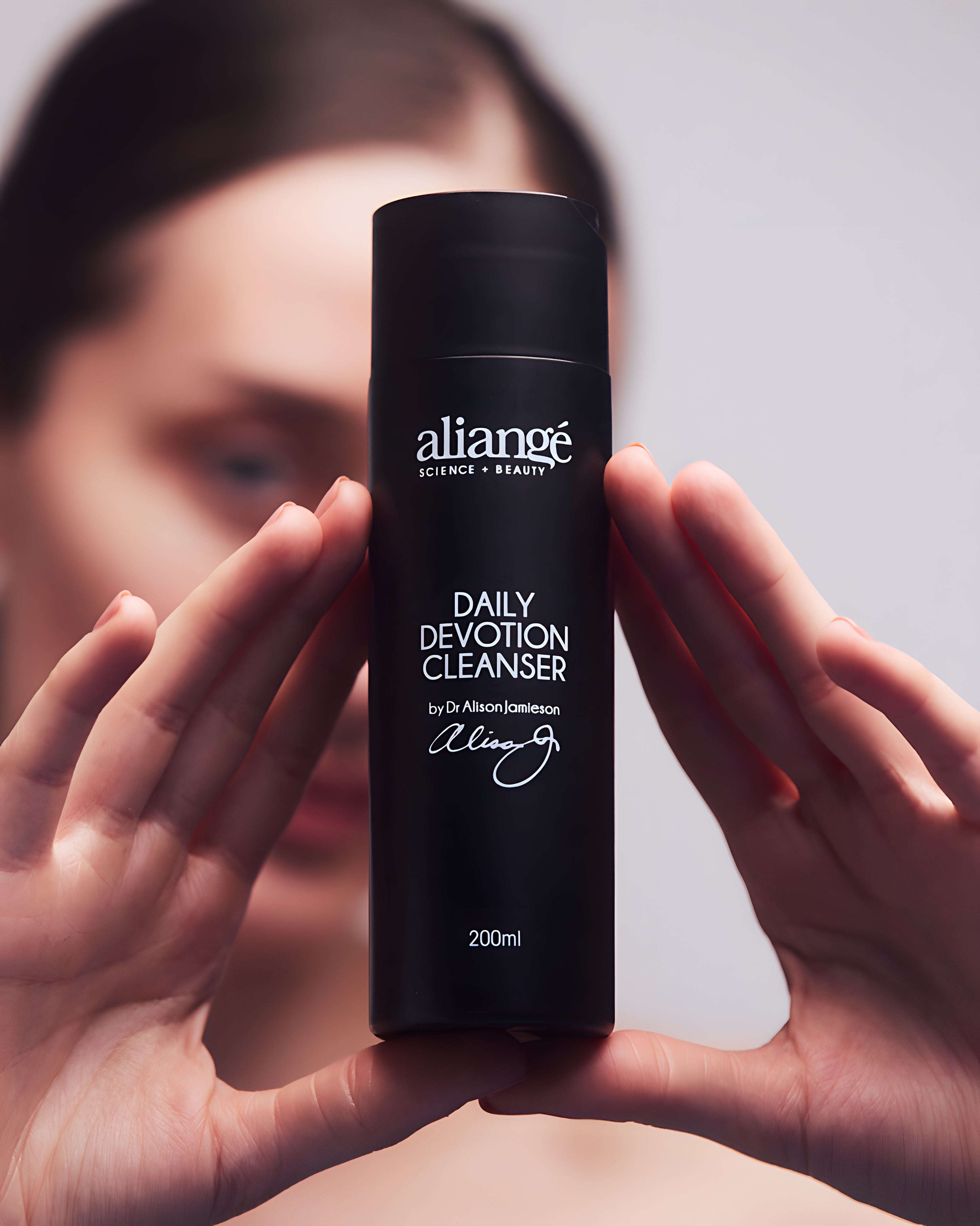Woman cleansing with Aliangé Daily Devotion Cleanser — daily cream cleanser lifestyle image
