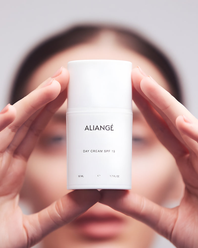 Woman applying Aliangé Day Cream SPF 15 — daily Queensland sun protection in use