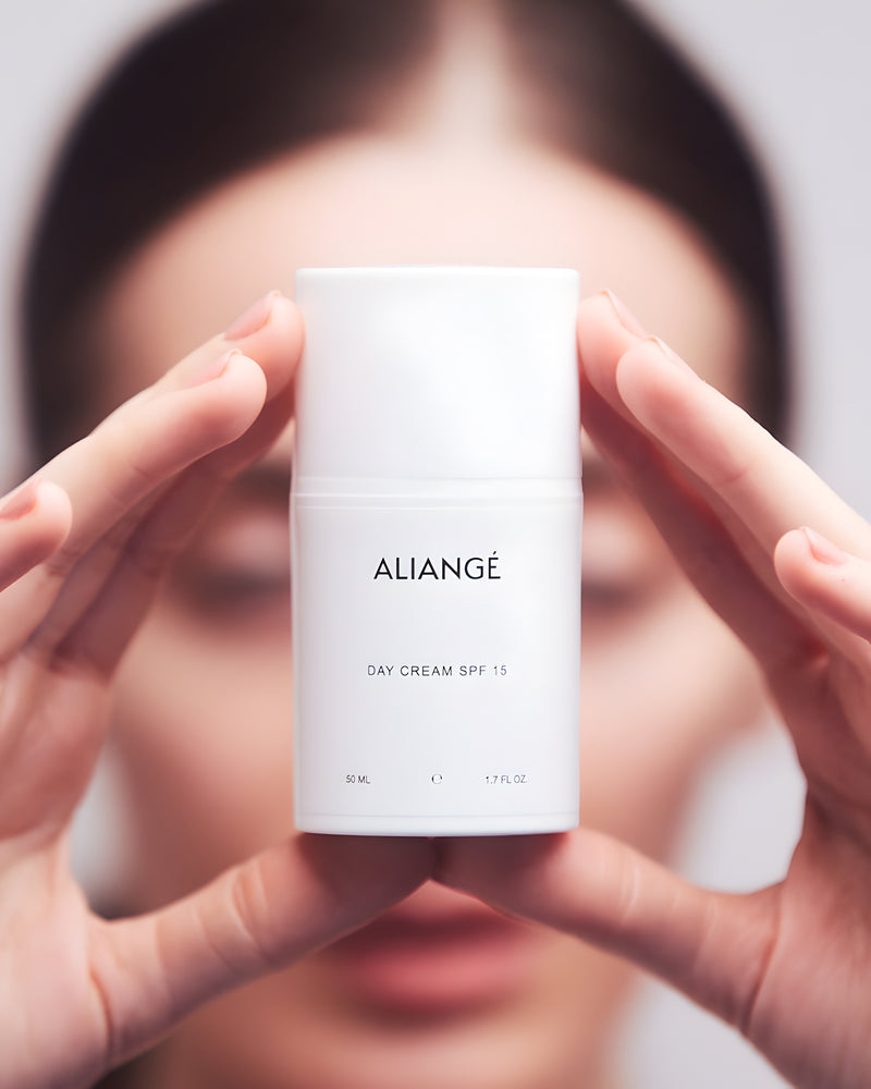 Woman applying Aliangé Day Cream SPF 15 — daily Queensland sun protection in use