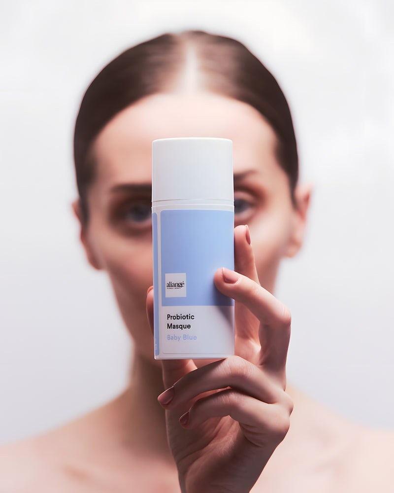 Woman applying Aliangé Probiotic Masque — probiotic microbiome treatment in use