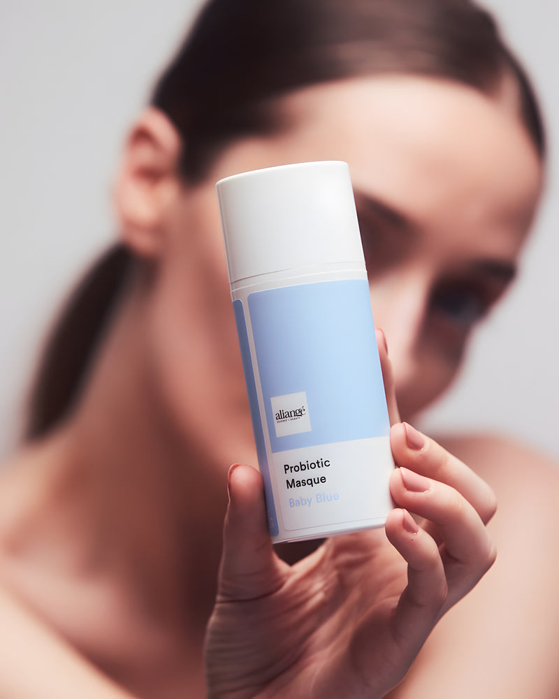 Woman applying Aliangé Probiotic Masque — probiotic microbiome treatment in use