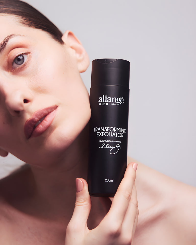 Woman using Aliangé Transforming Exfoliator — AHA tea tree resurfacing wash in use